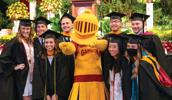 Graduates with the Gannon Knight mascot.