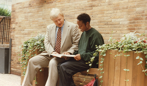 Duane Prokop, Ph.D., a professor in the Dahlkemper School of Business since 1981, seated with a student.